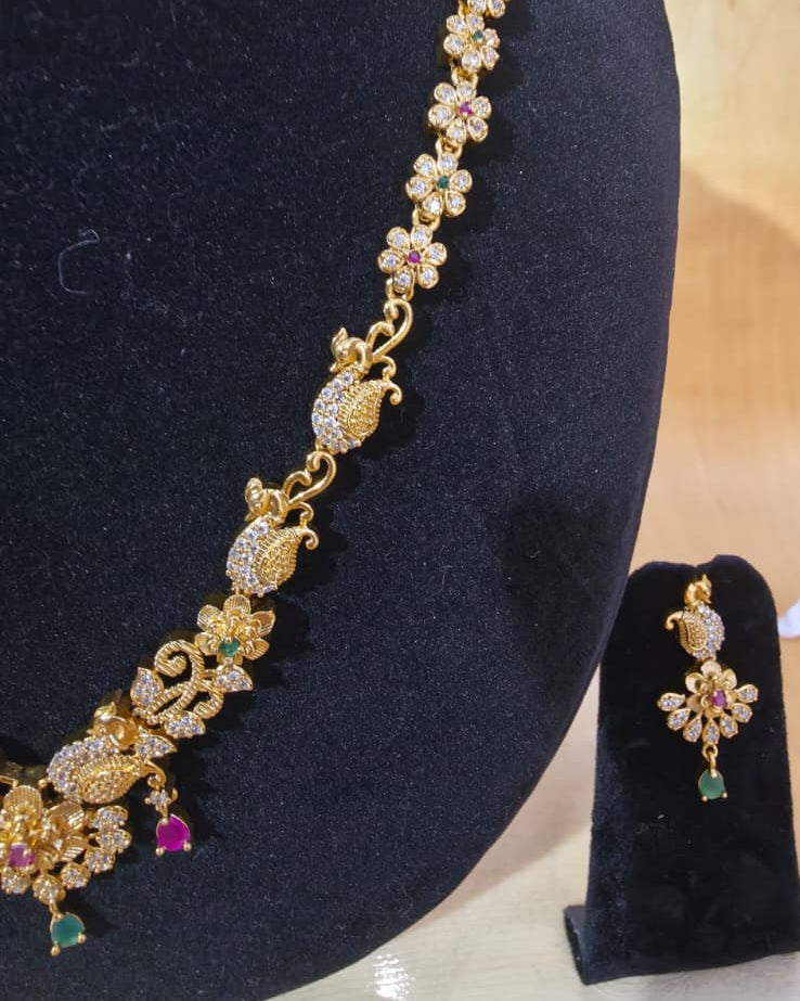 Temple gold tone peacock and flower necklace