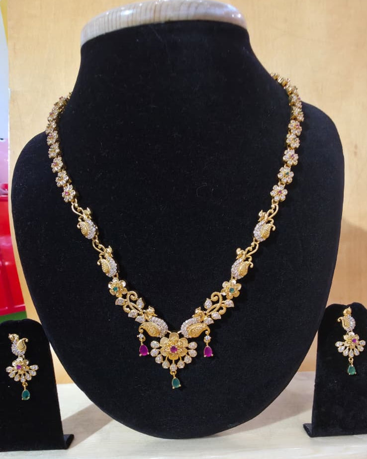 Temple gold tone peacock and flower necklace